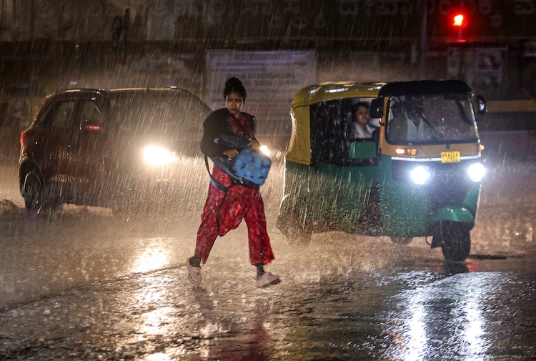 Commuters wade through a waterlogged road in Delhi. (Photo: PTI)