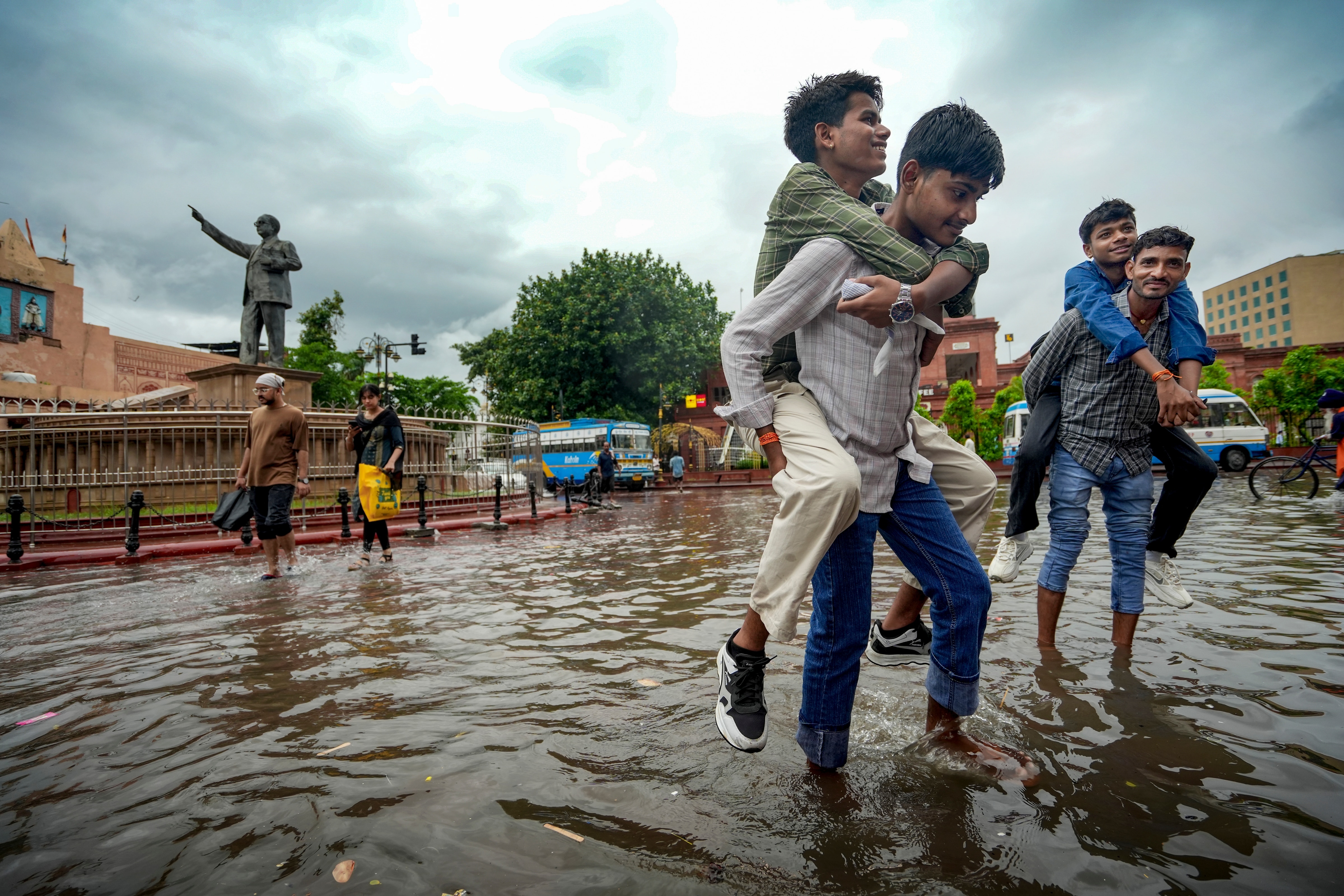 People commute through a waterlogged road after a heavy spell of monsoon rain. (Photo: PTI)