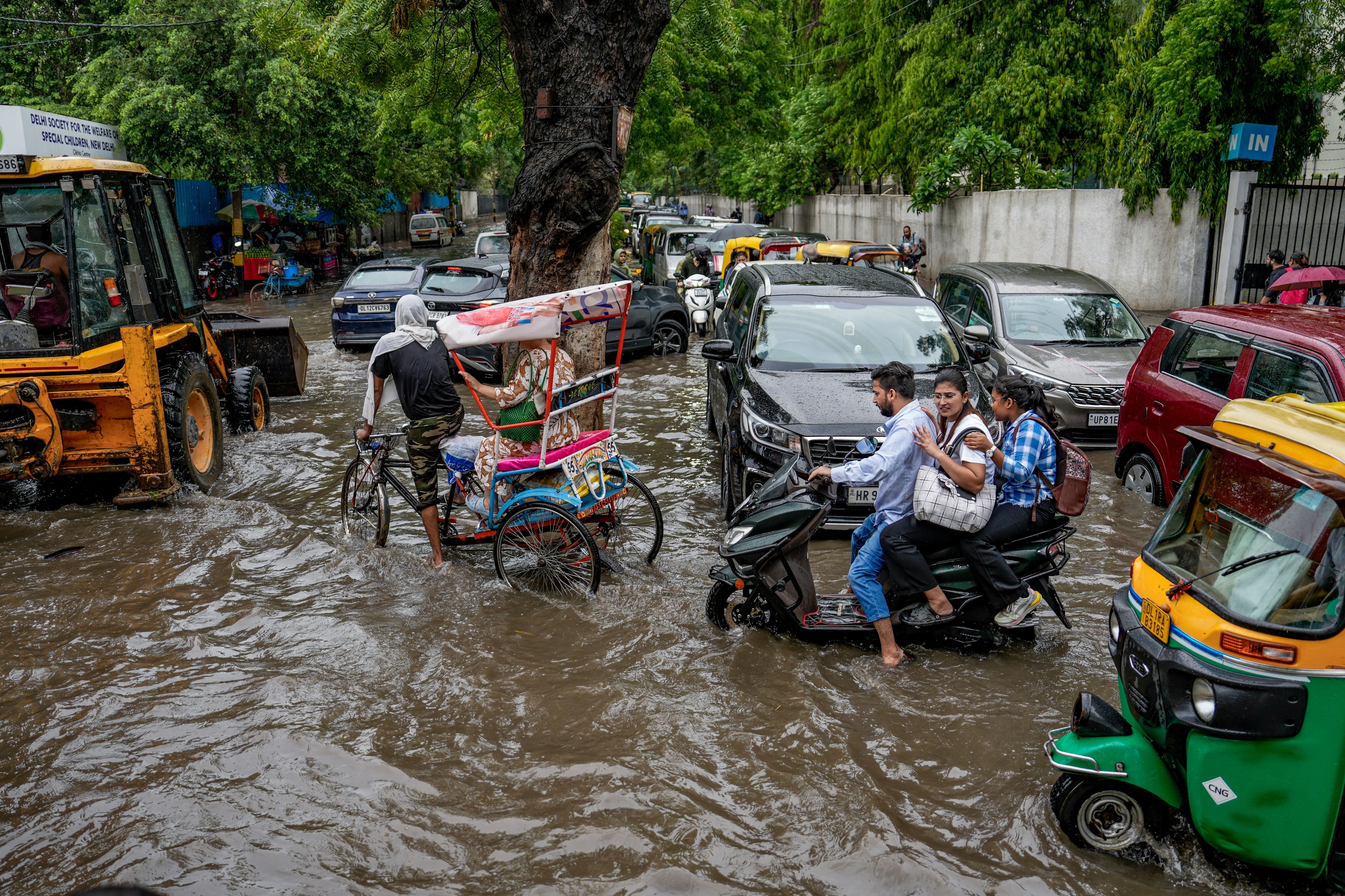 People drive through a waterlogged street after heavy monsoon rain. (Photo: PTI)