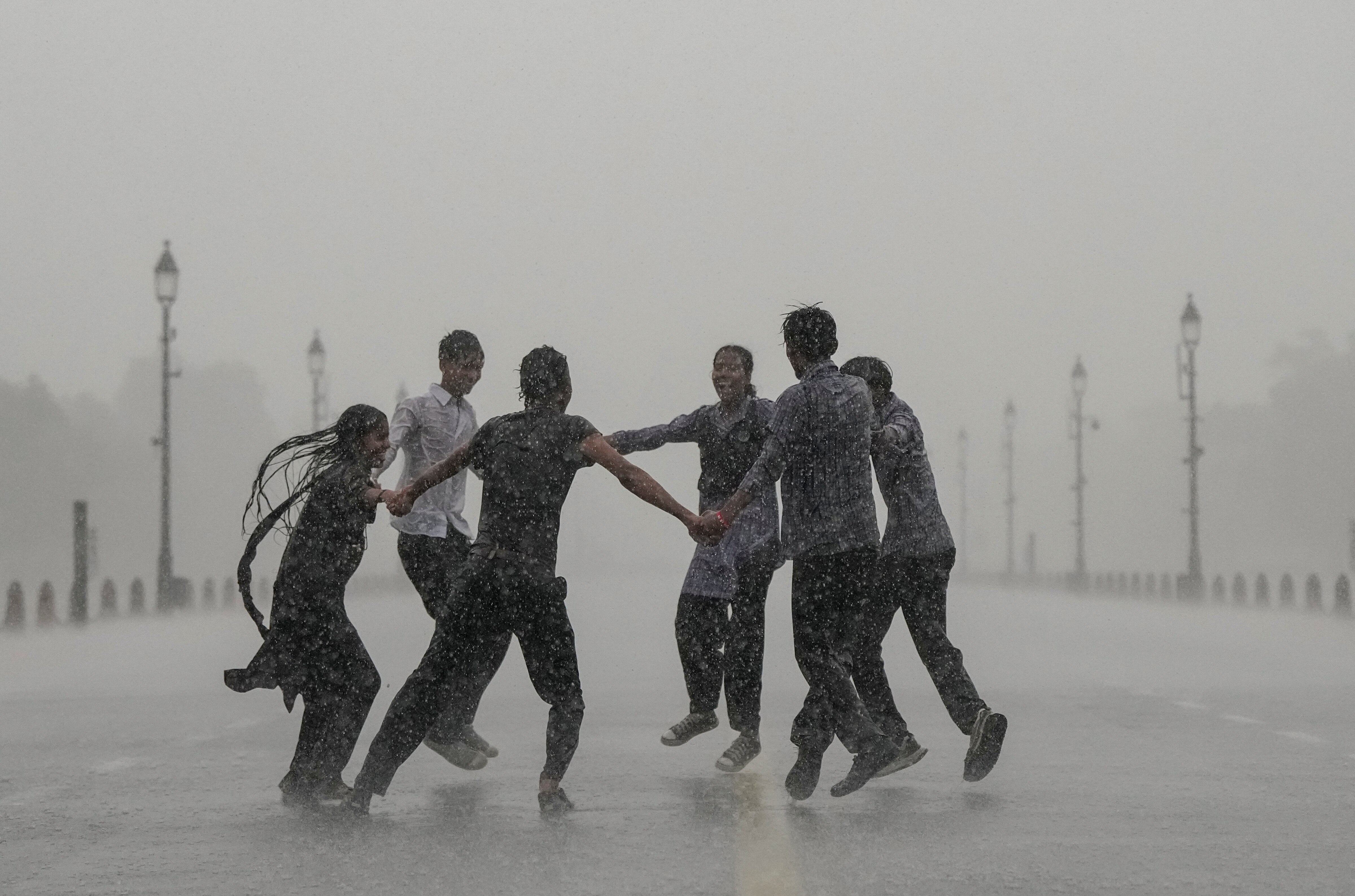 Students play at Kartavya Path amid monsoon showers, in New Delhi. (Photo: PTI)