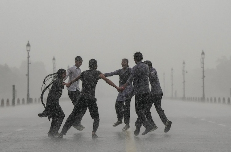 Students play at Kartavya Path amid monsoon showers, in New Delhi. (Photo: PTI)
