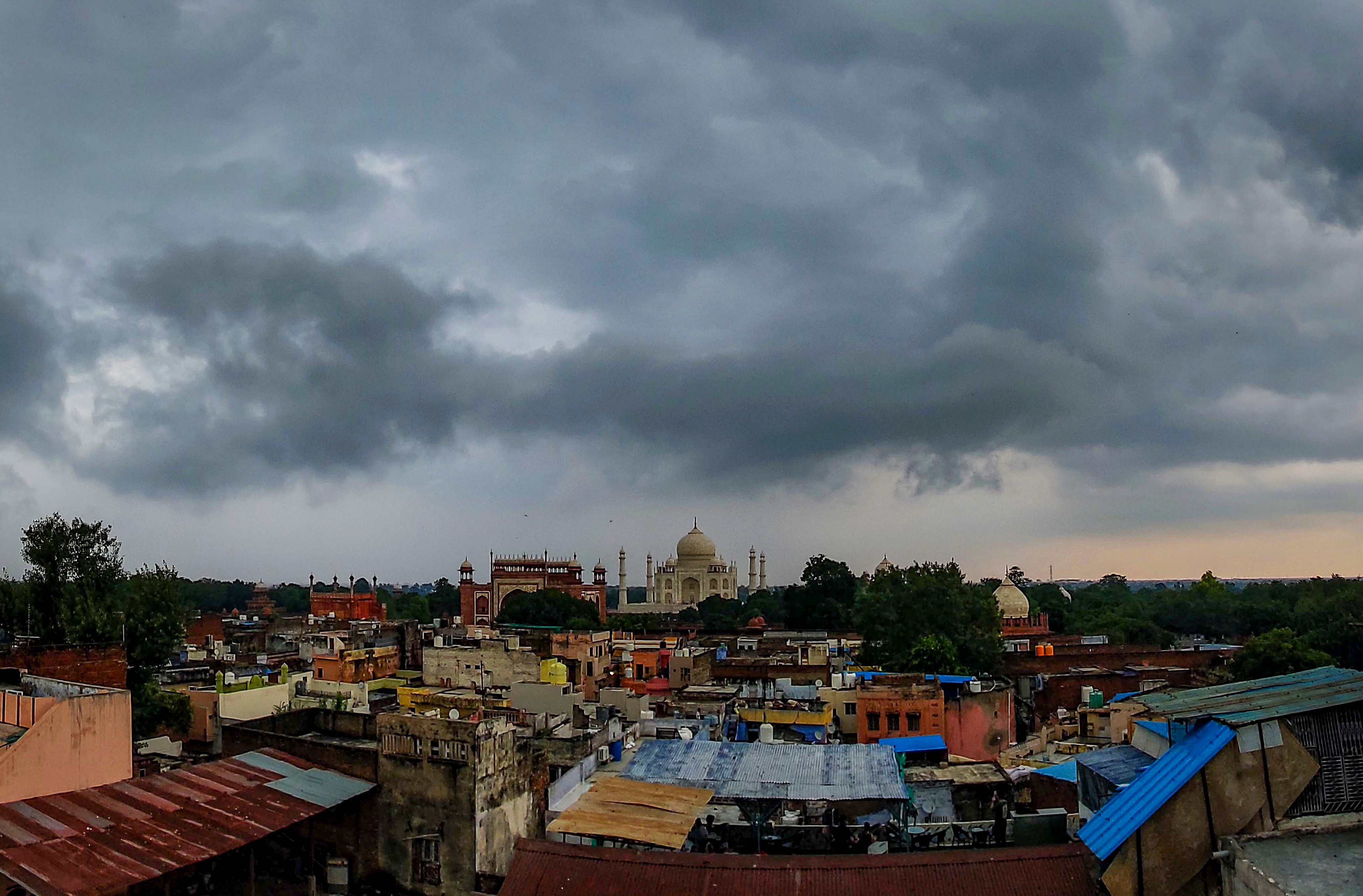 Dark monsoon clouds hover in the sky over the Taj Mahal, in Agra. (Photo: PTI)