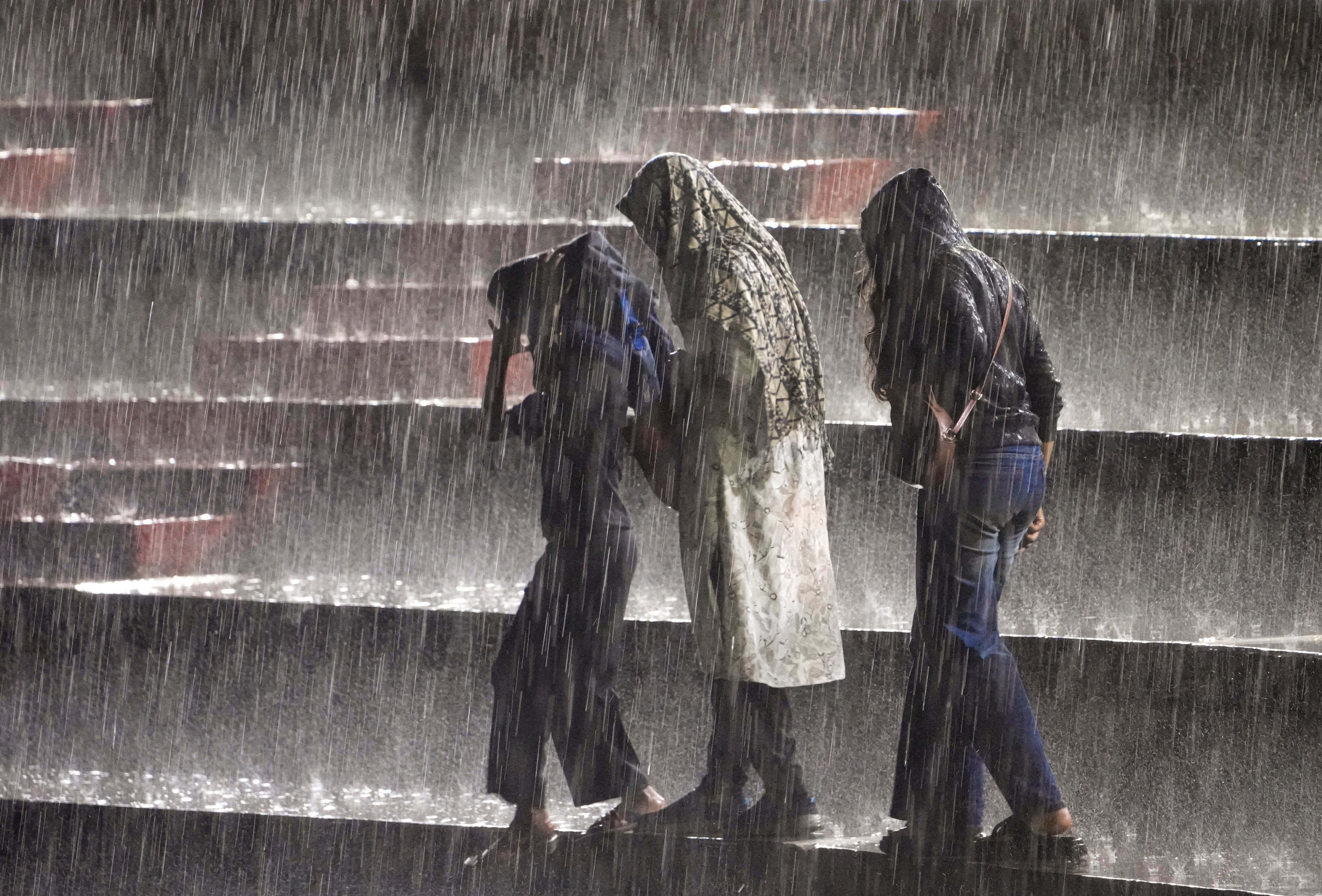 People walk down the stairs amid heavy monsoon rainfall in Andhra Pradesh. (Photo: PTI)