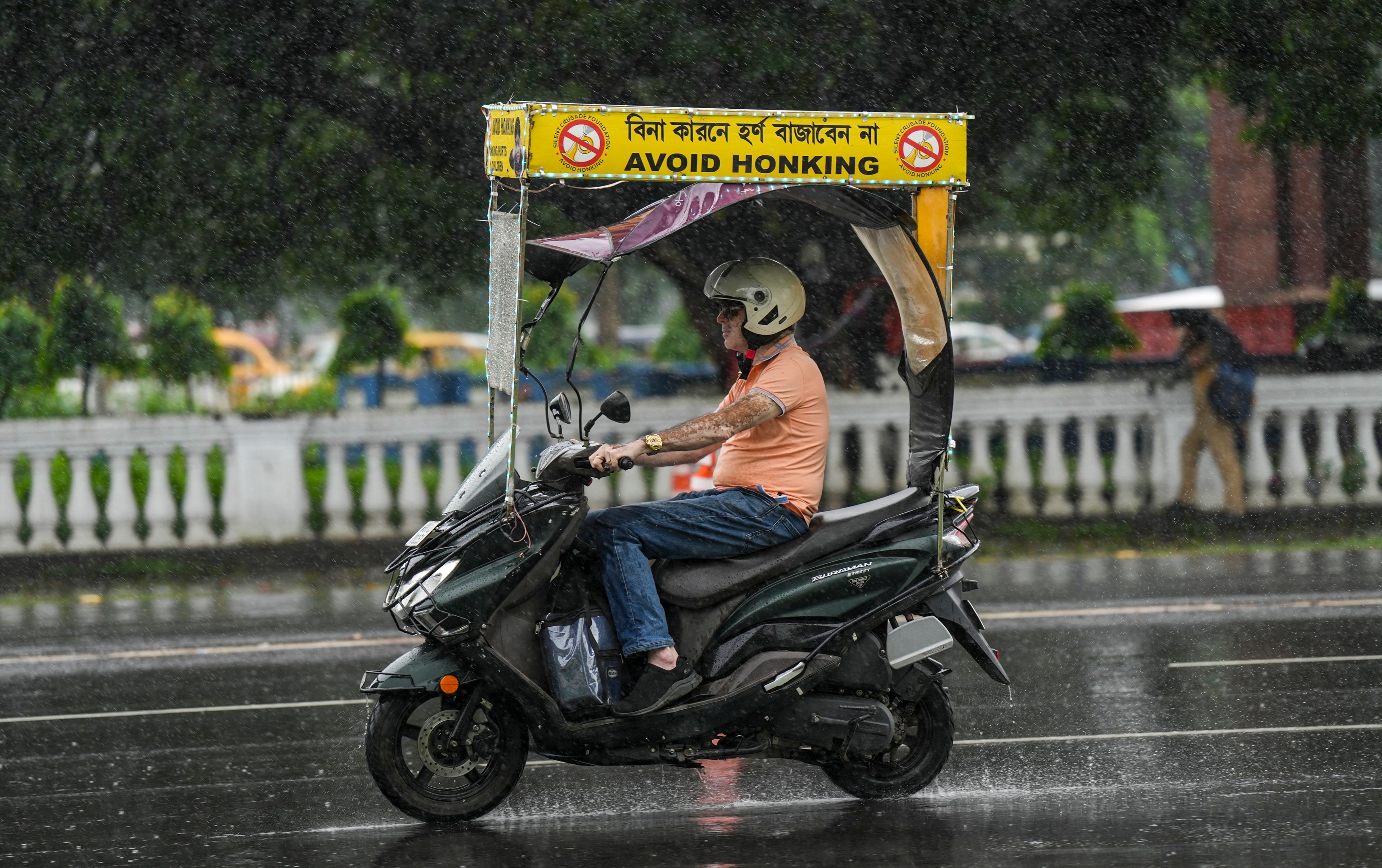 A commuter wades through rain. (Photo: PTI)