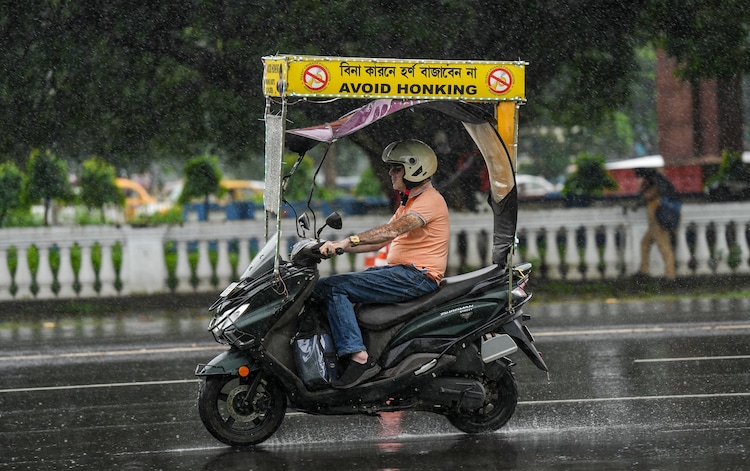 A commuter wades through rain. (Photo: PTI)