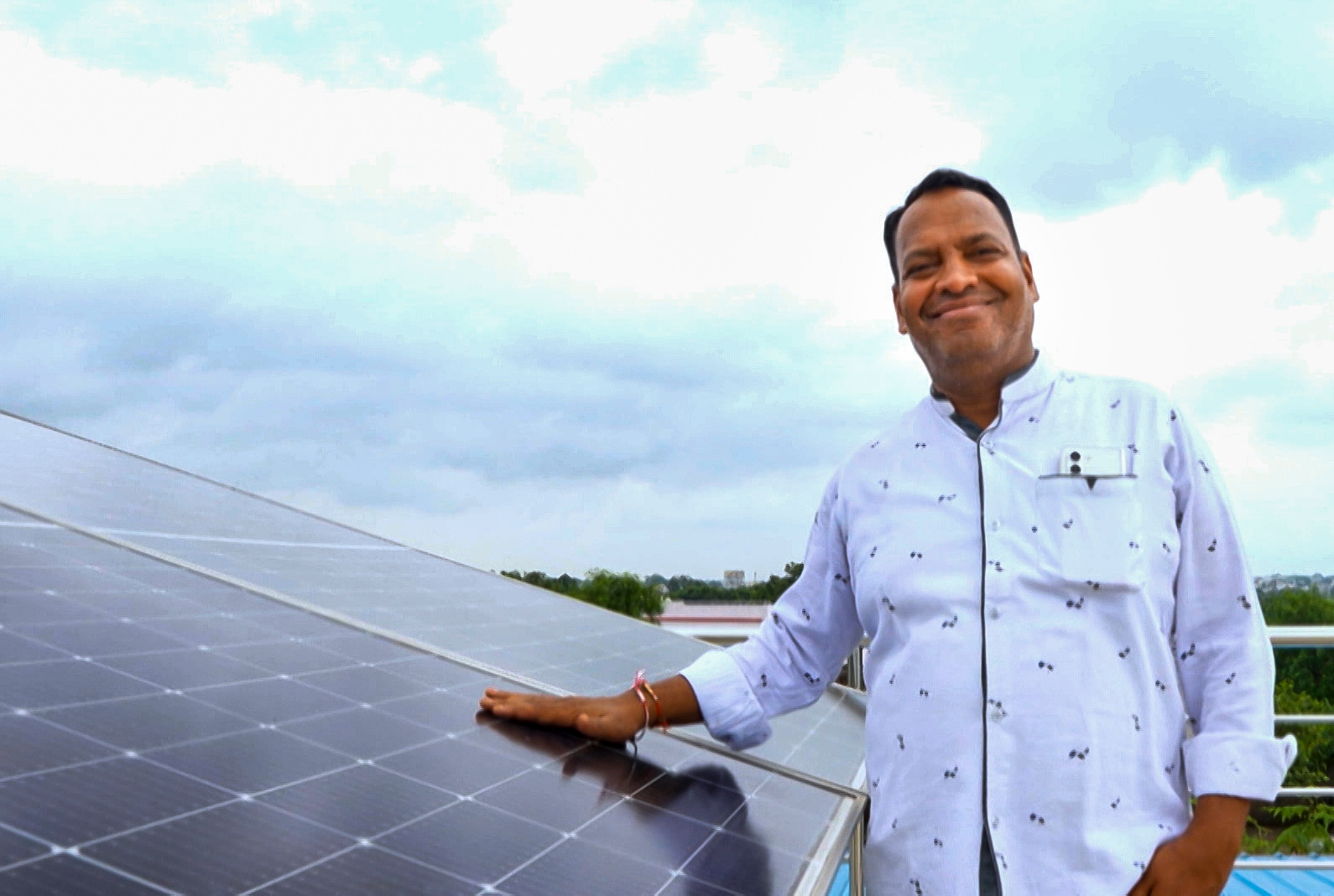 Beneficiary of PM Surya Ghar stands next to his rooftop solar panels in Chhattisgarh . (Photo: PTI) 