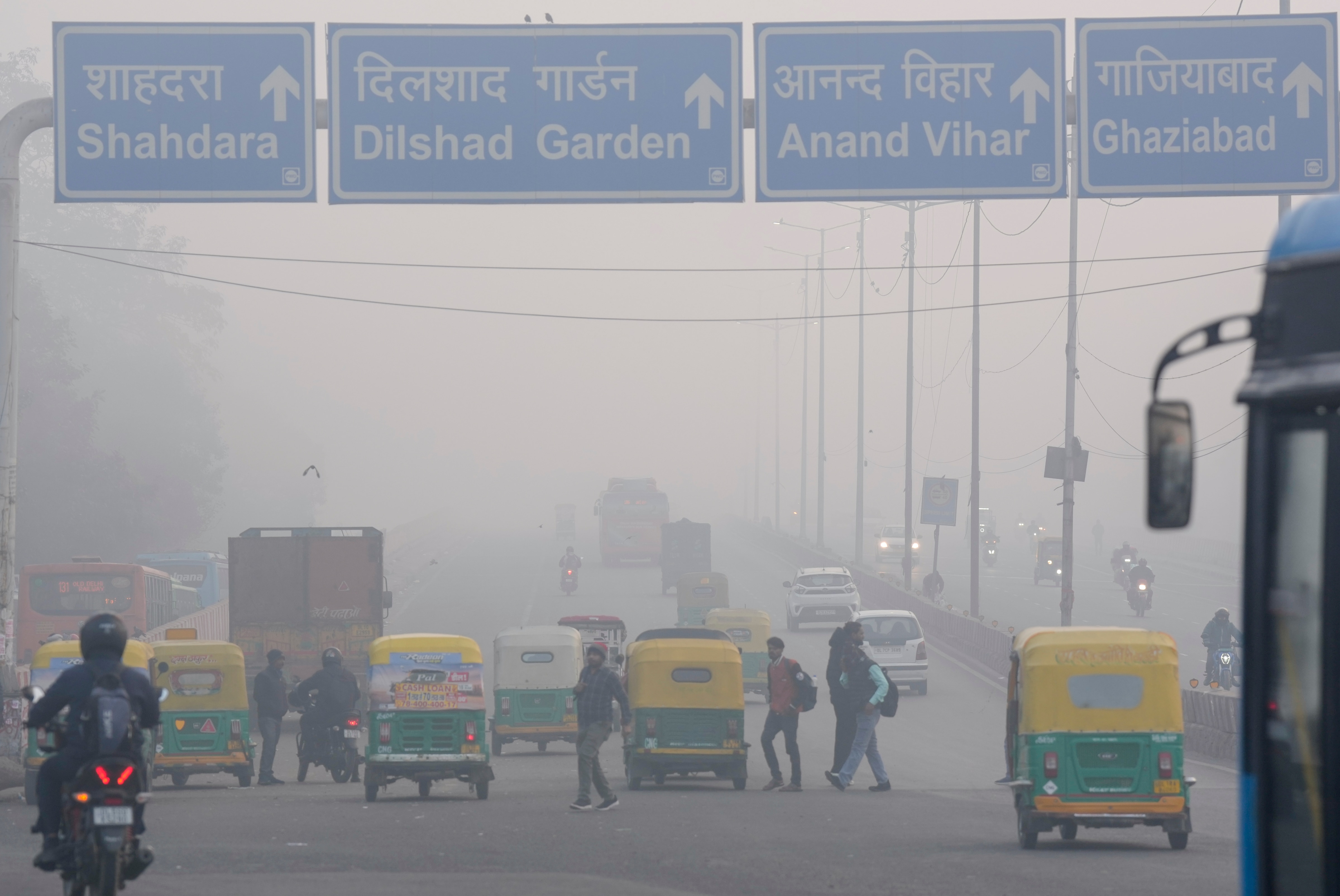 Vehicles move on a road amid low visibility due to a layer of smog, in New Delhi. (Photo: PTI)