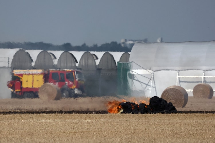 View of burning haystacks in a field at a farm during a Europe-wide heatwave. (Photo: Reuters)