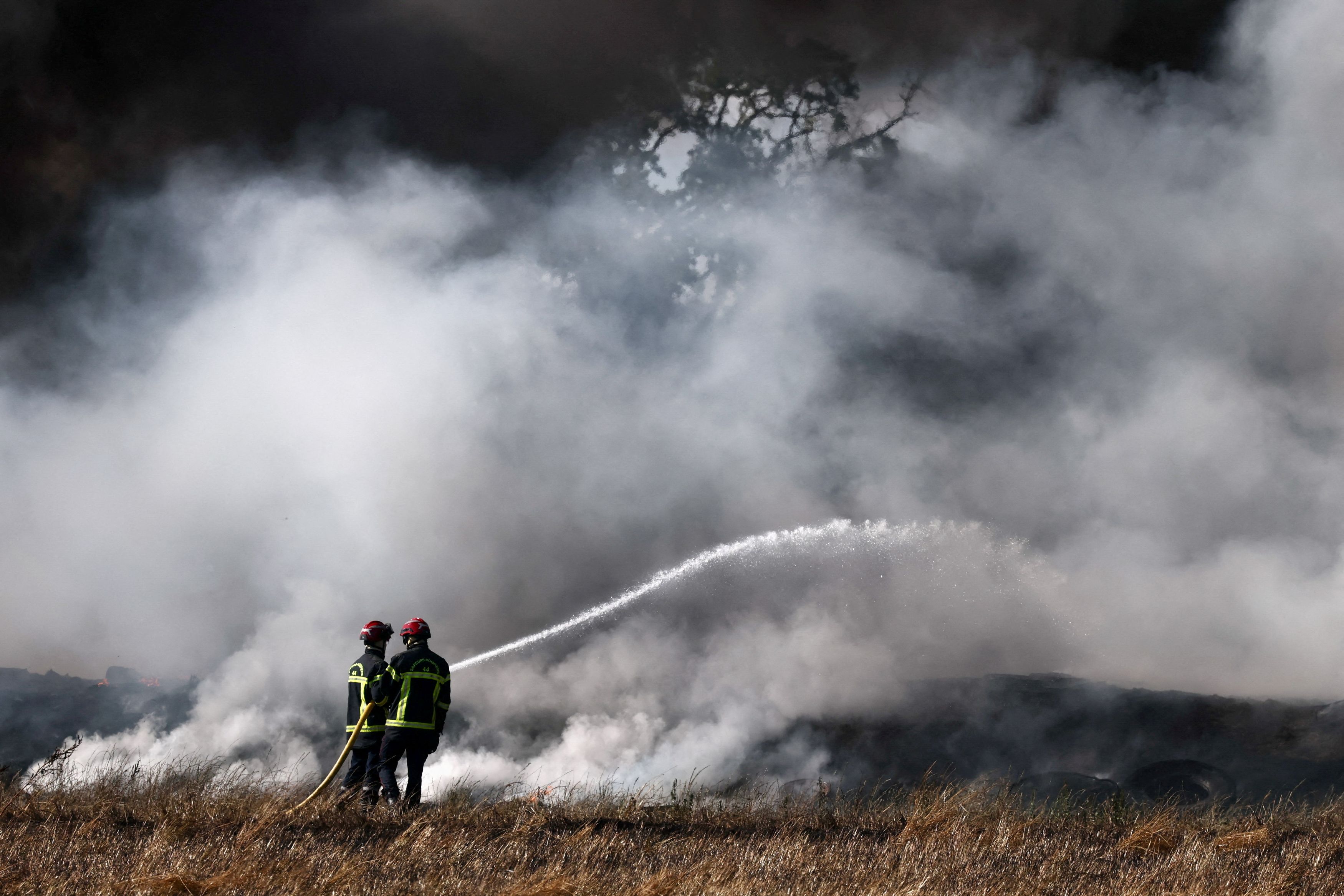 French firefighters work to extinguish a fire near a farm in France. (Photo: Reuters)
