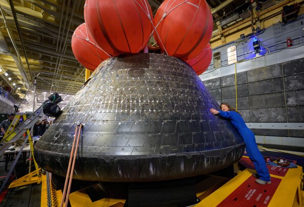 Nasa astronaut Christina Koch hugs the Orion spacecraft after splashing down. (Photo: Reuters)