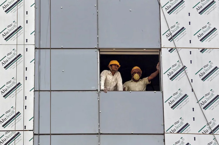 Labourers look out from a window of a data centre building under construction in Gujarat. (Photo: Reuters)