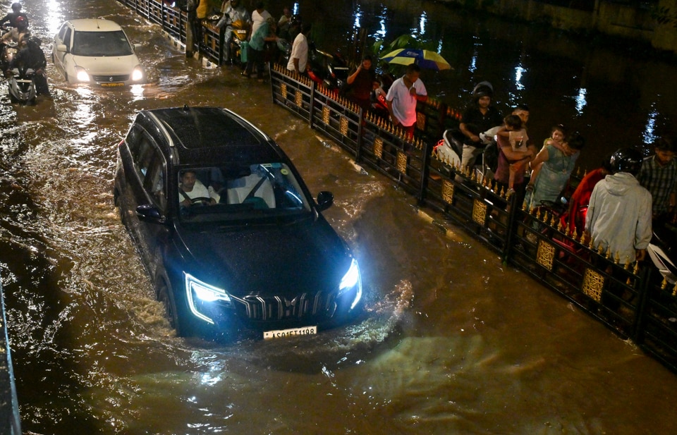 Vehicles make their way through a waterlogged road after heavy rain, in Guwahati, Assam. (Photo: PTI)