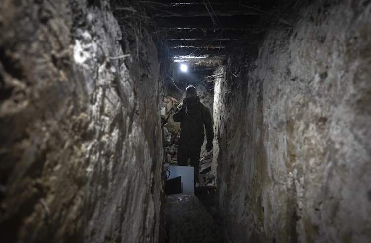 A Ukrainian soldier works with an electronic warfare system to listen to Russian chatter in a shelter at the front line. (Photo: AP)