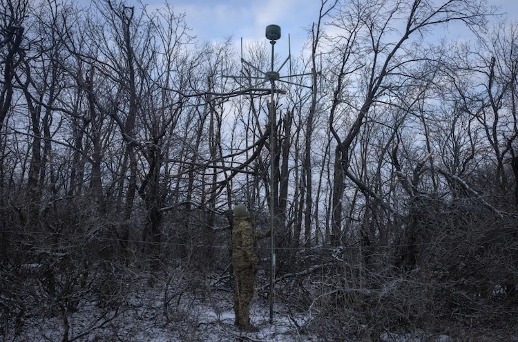 A Ukrainian soldier works with an electronic warfare system to listen to Russian chatter in a shelter at the front line. (Photo: AP)