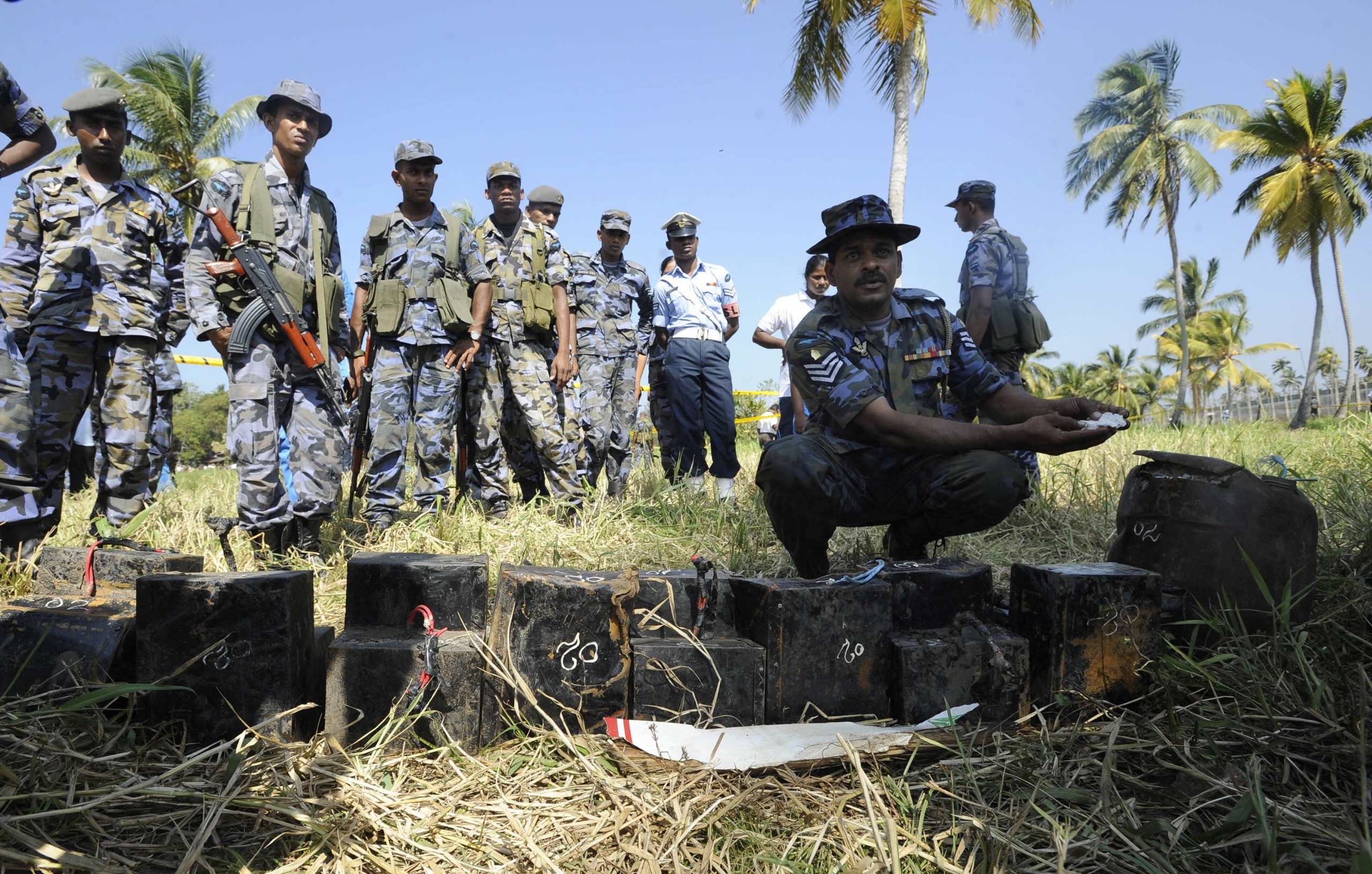 A Sri Lankan Civil War scene: an Air Force officer inspects debris of a downed LTTE aircraft near Colombo after a 2009 attack. (Photo: AFP)
