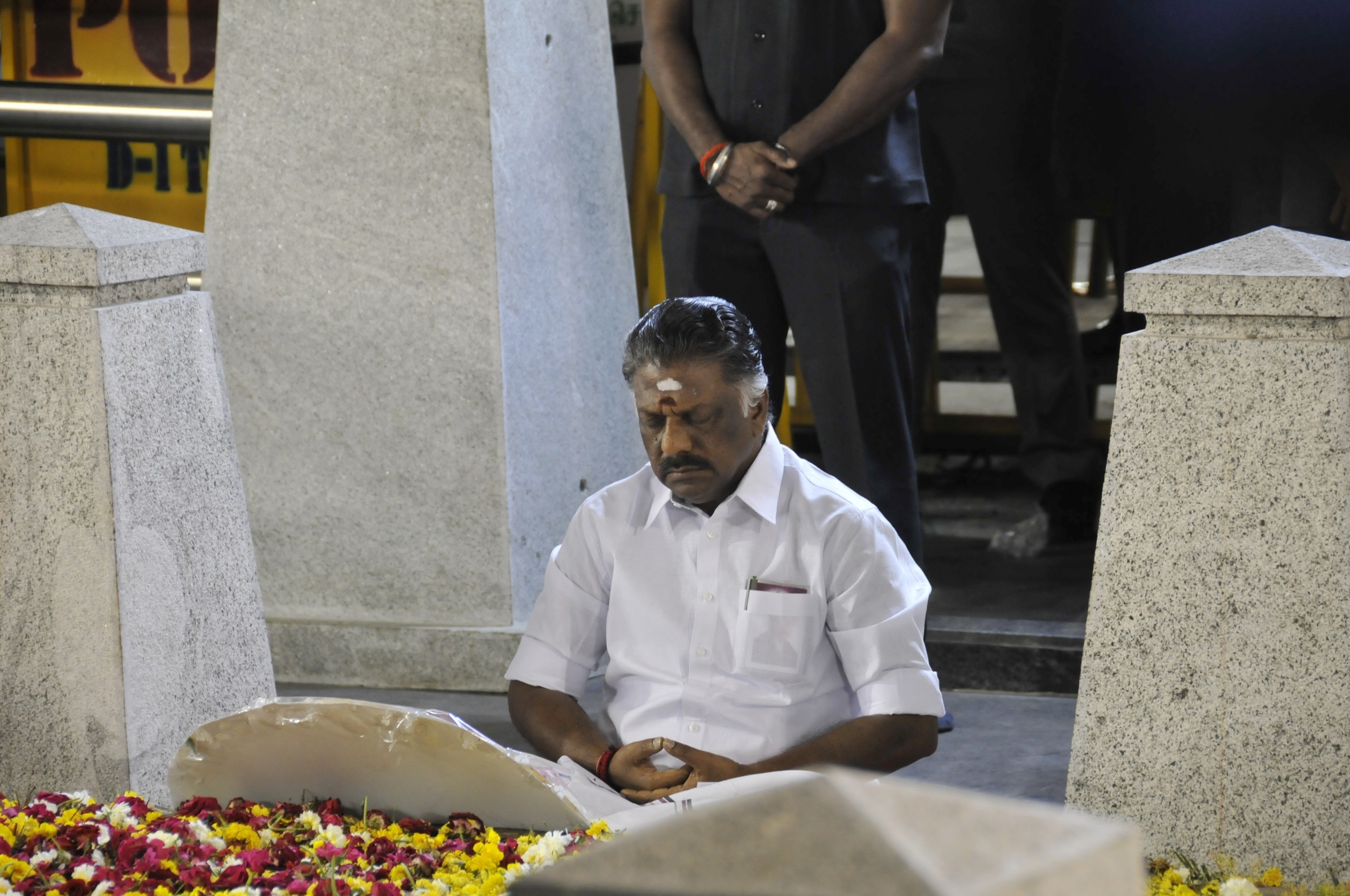 O. Panneerselvam, then Chief Minister of Tamil Nadu, meditates at the burial site of J. Jayalalithaa on Marina Beach in Chennai. (India Today)