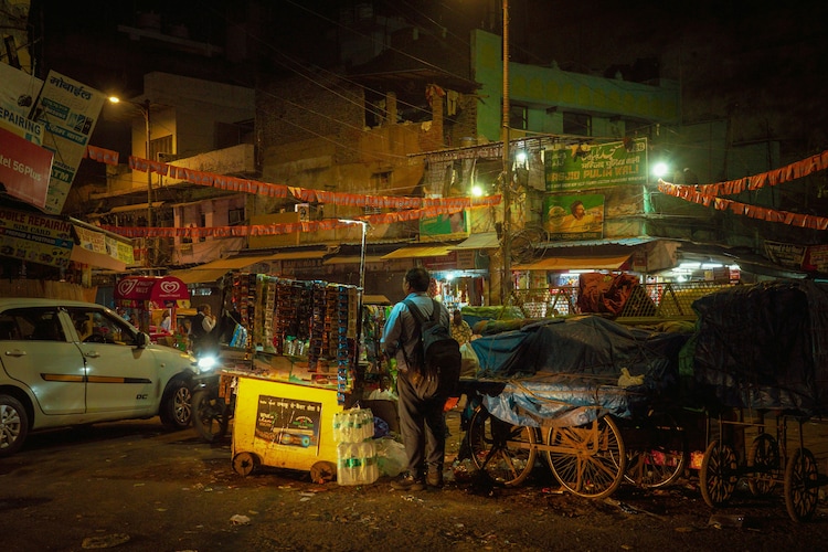 An informal stall is seen at night in a dense Delhi neighbourhood. (Photo: Unsplash)