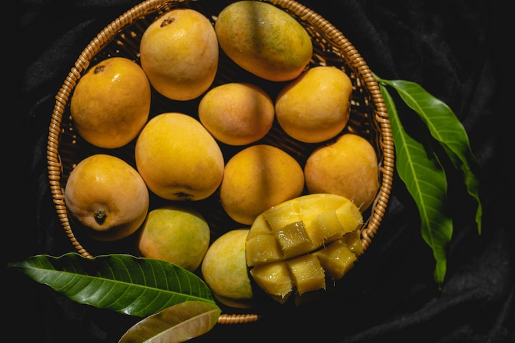 An image of mangoes sitting in a basket. (Photo: Unsplash)