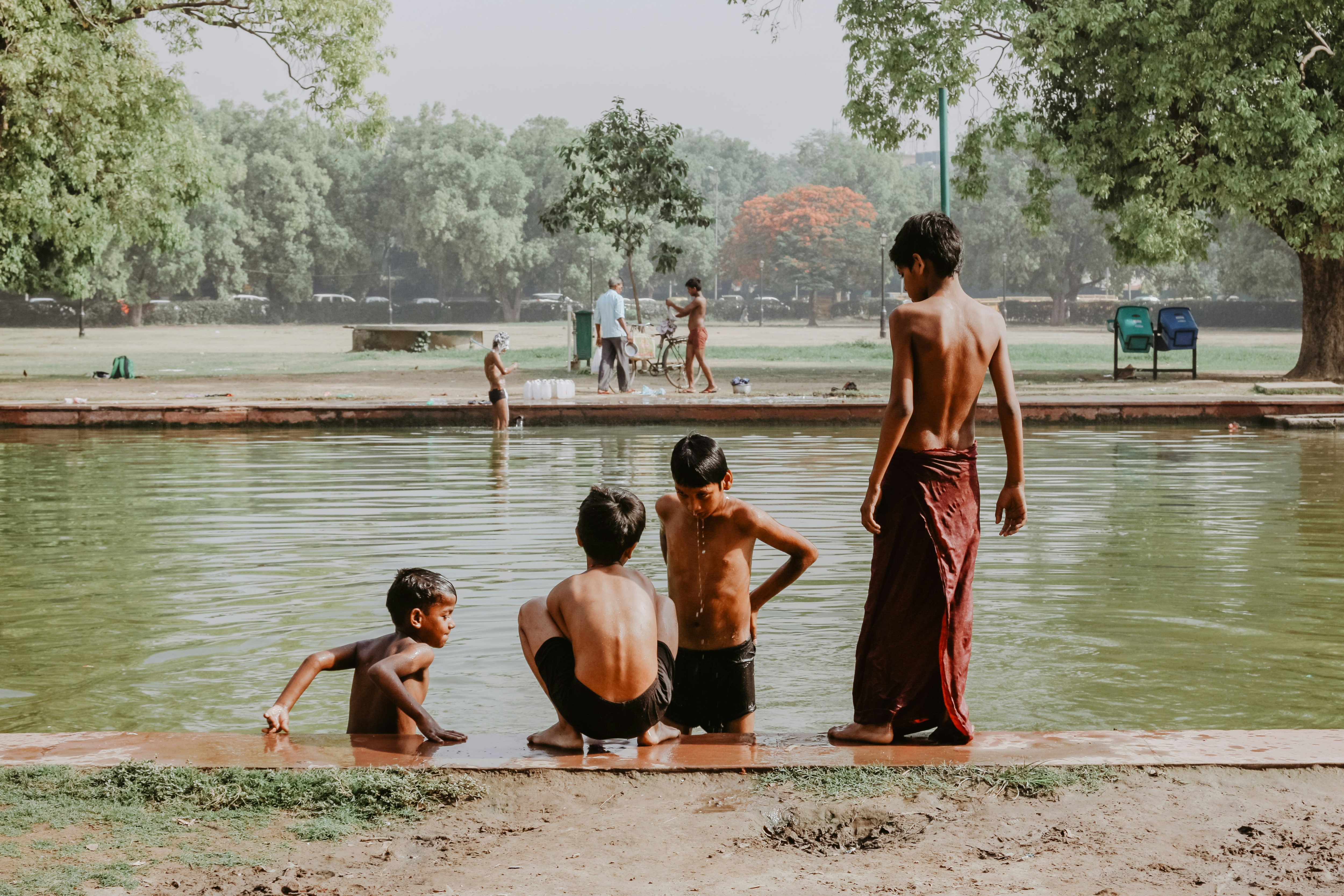Young boys bathe in a river new India gate, Delhi, to beat the heat. (Photo: Unsplash)