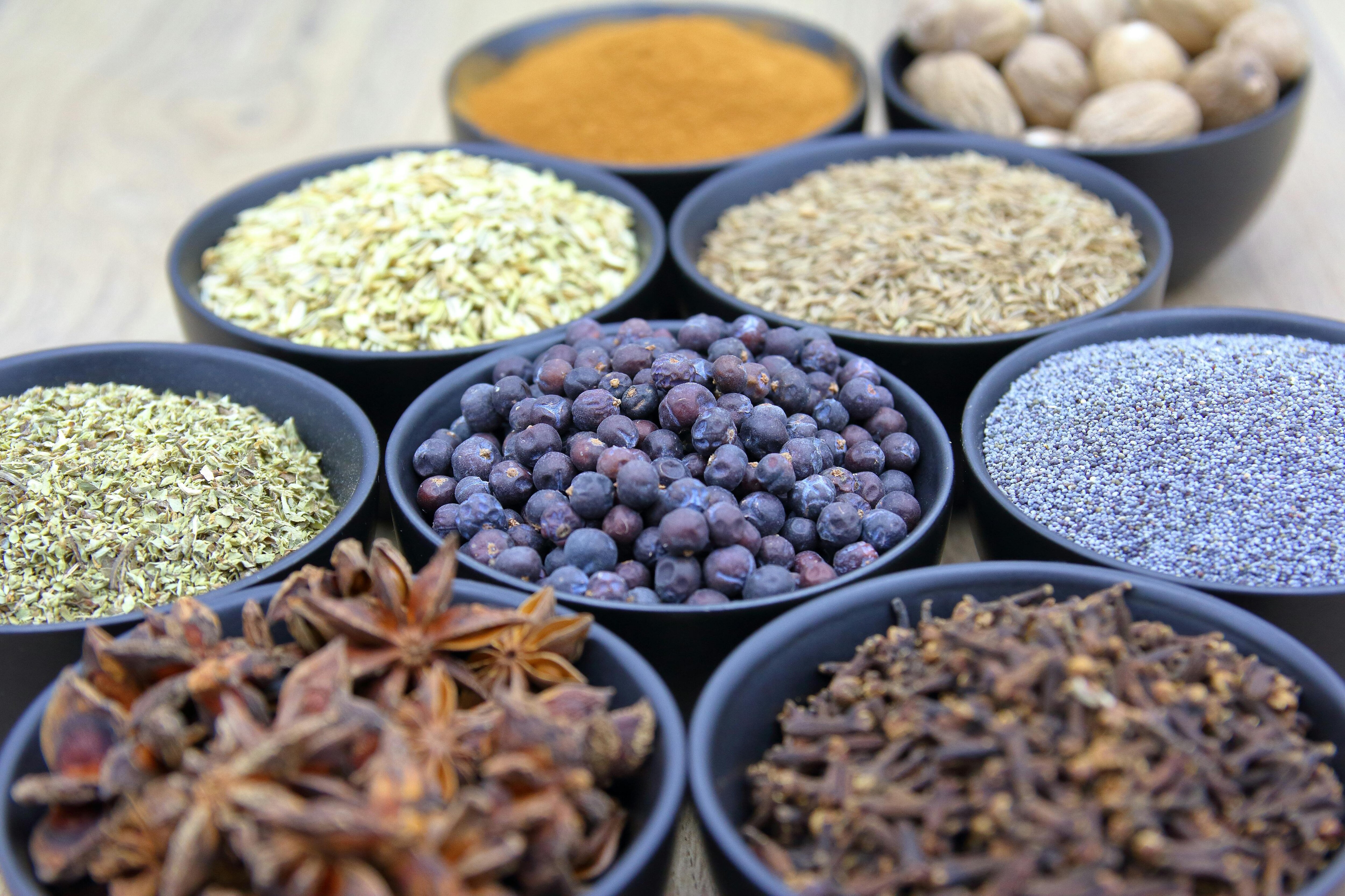 Spices like star anise, nutmegs, and cloves are seen stores in separate bowls. (Photo: Getty)