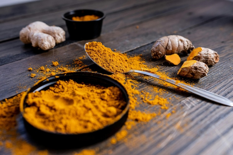 An image of a bright yellow turmeric powder sitting in a bowl. (Photo: Pexels)