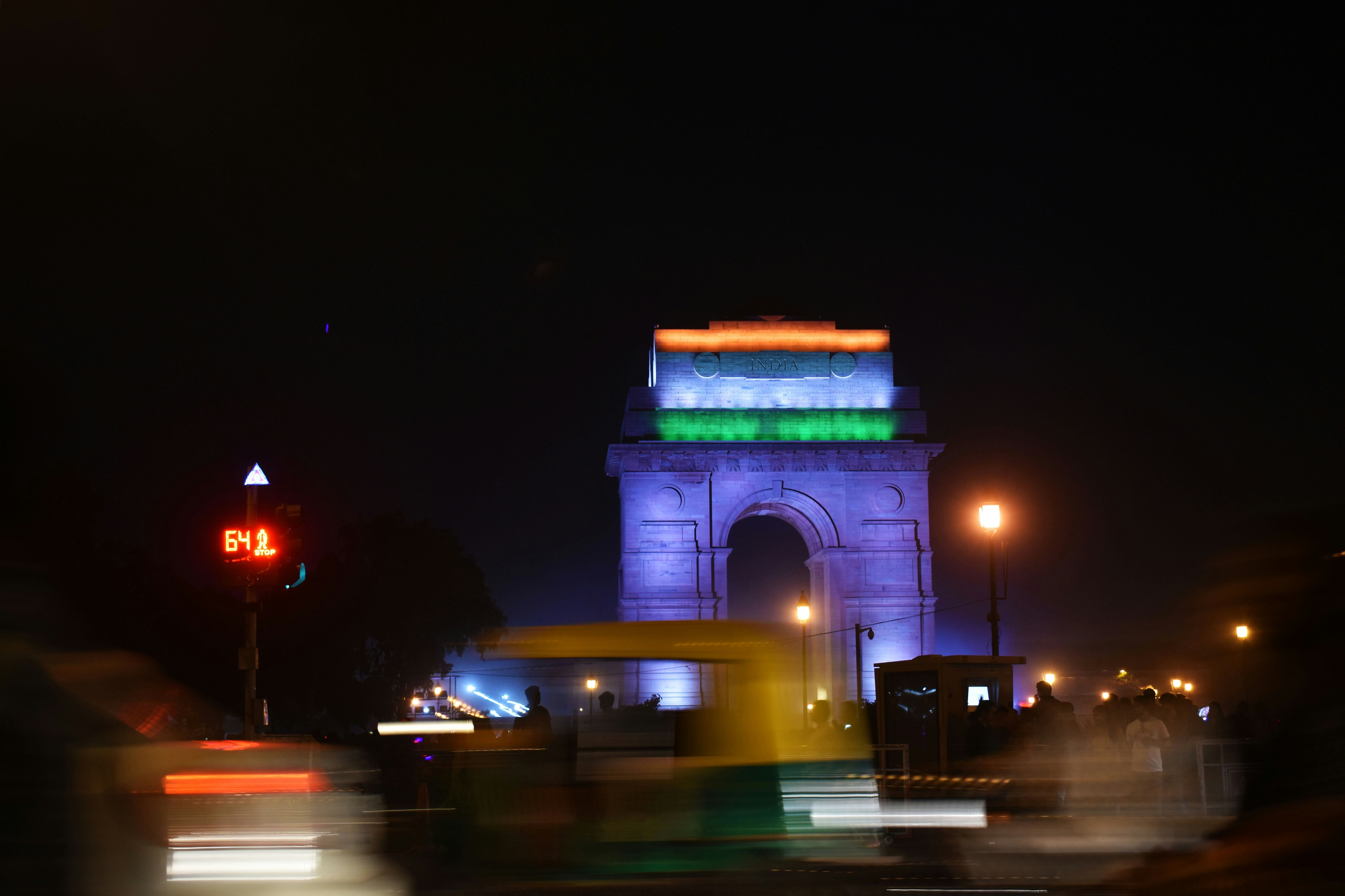 Vehicles drive by on a warm night in New Delhi. (Photo: Unsplash)