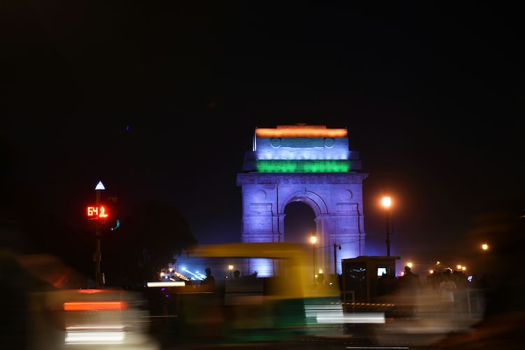 Vehicles drive by on a warm night in New Delhi. (Photo: Unsplash)