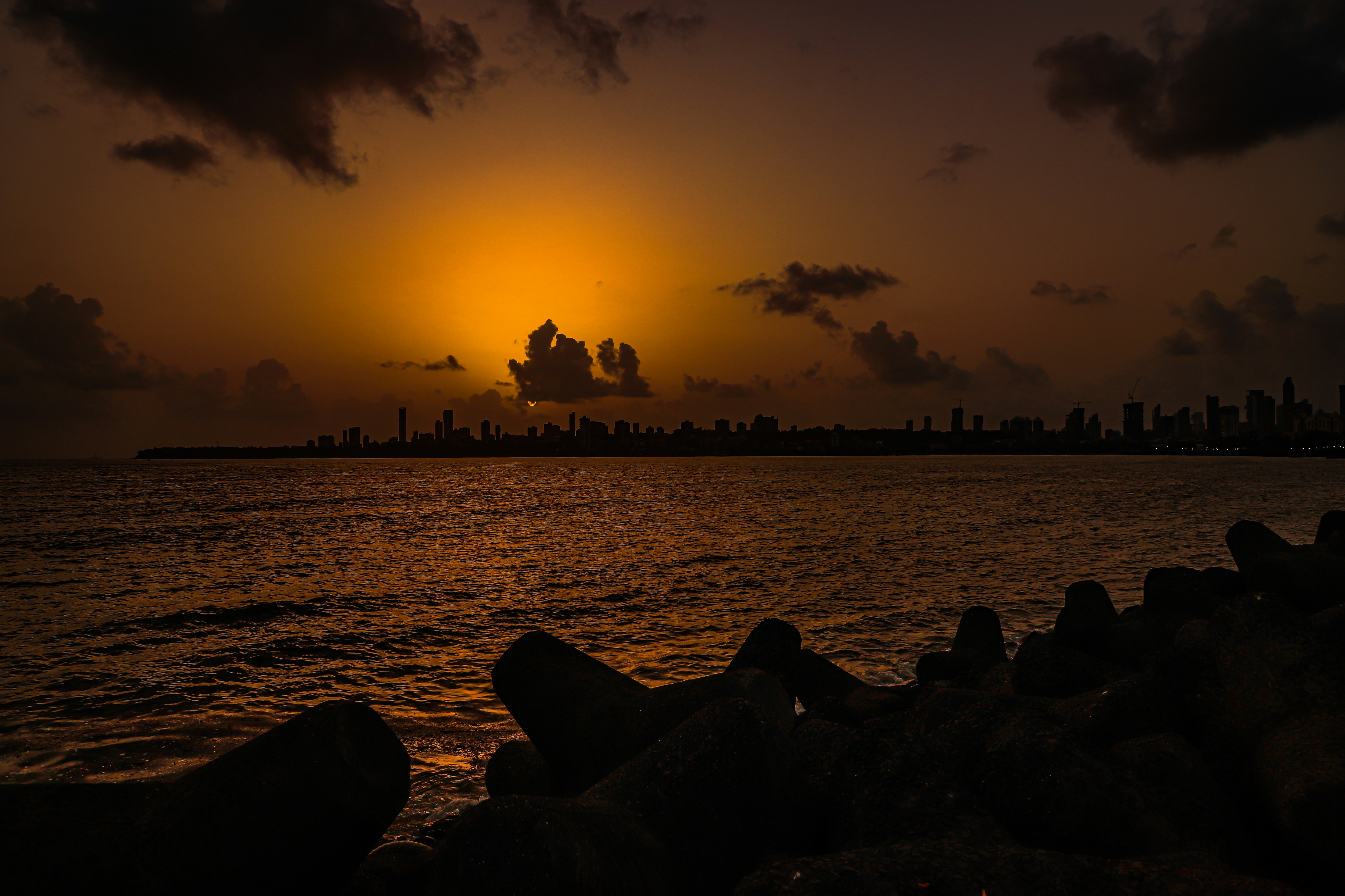 The Sun is seen setting above the Mumbai skyline. (Photo: Unsplash)