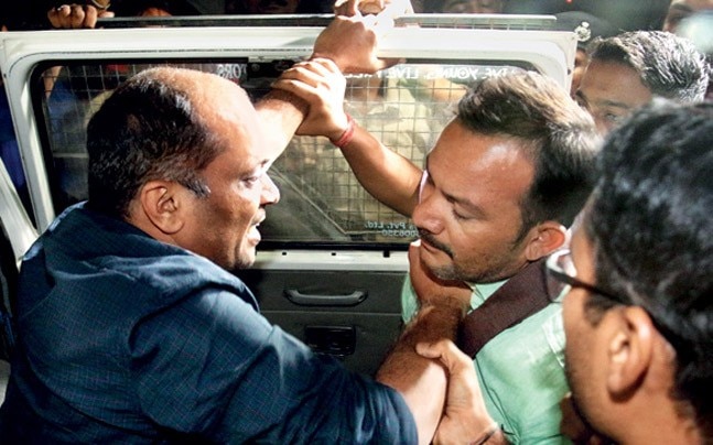 PATEL RAP PAAS co-convenor Bhambhania (left) fends off an angry protester. Photo: Shailesh Raval