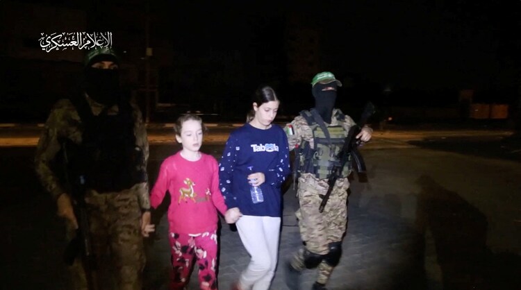 Hostages being handed over by Hamas to International Committee of the Red Cross