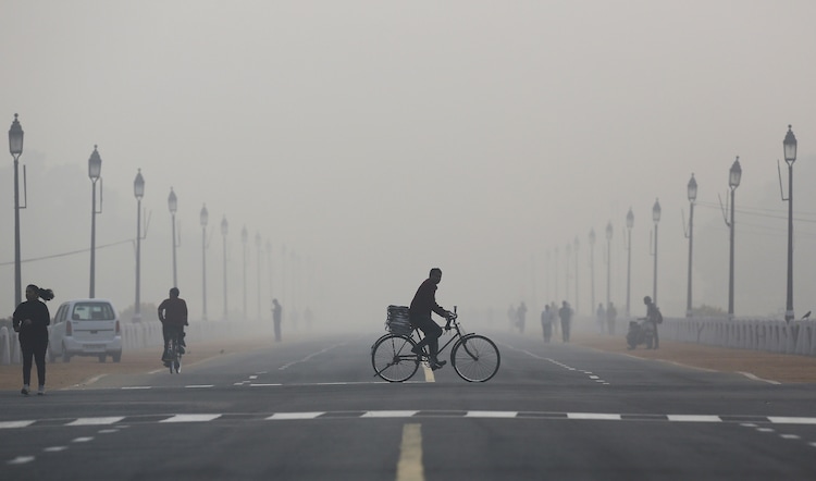 People cycle, run and walk through thick smog in Delhi. The city recorded zero clean-air days in 2025, making it one of the most persistently polluted capitals in the world. (Photo: Reuters)