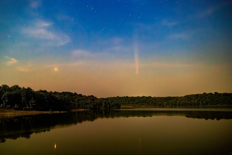 A comet trails across the night sky above a still lake at Pench Tiger Reserve, where the absence of artificial light makes such rare sightings possible. (Photo: Special arrangement/Pench Tiger Reserve)