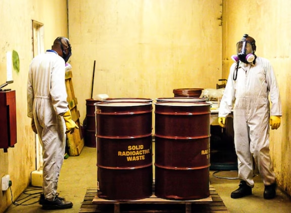 Iran war triggers N-race. But these countries gave up their nukes 3 South African workers inspect radioactive waste drums in 2005, years after the country dismantled its secret nuclear programme. (Image: AFP)