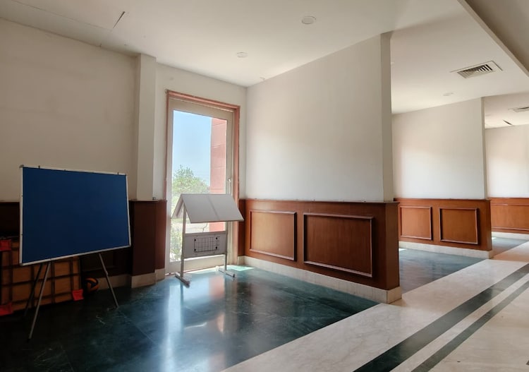 The empty notice board in the corner of the hostel