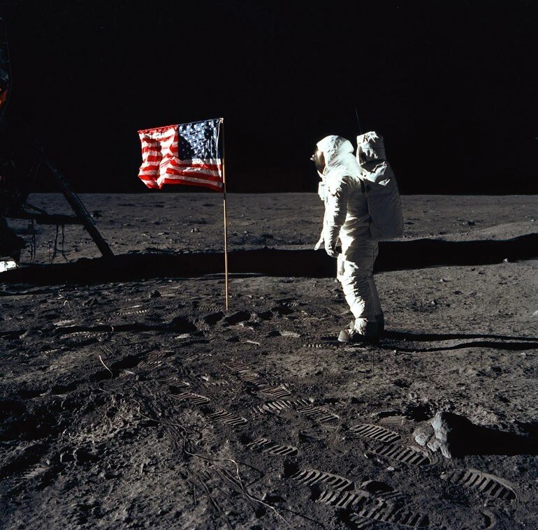 The second human to walk on the moon after Neil Armstrong, Buzz Aldrin is seen here poses for a photograph beside the deployed US flag.