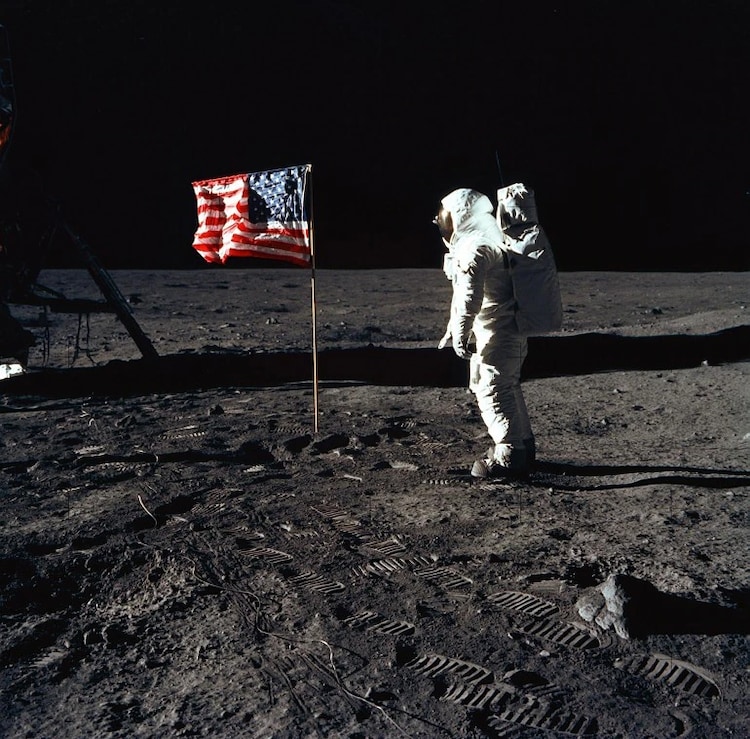 The second human to walk on the moon after Neil Armstrong, Buzz Aldrin is seen here poses for a photograph beside the deployed US flag.