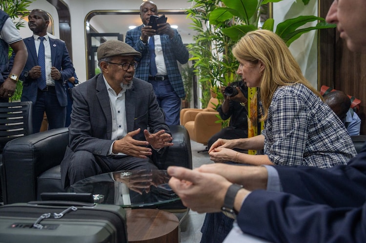 Dr. Tedros Adhanom Ghebreyesus (L), the Director-General of the World Health Organization (WHO), speaks with officials upon his arrival in Kinshasa