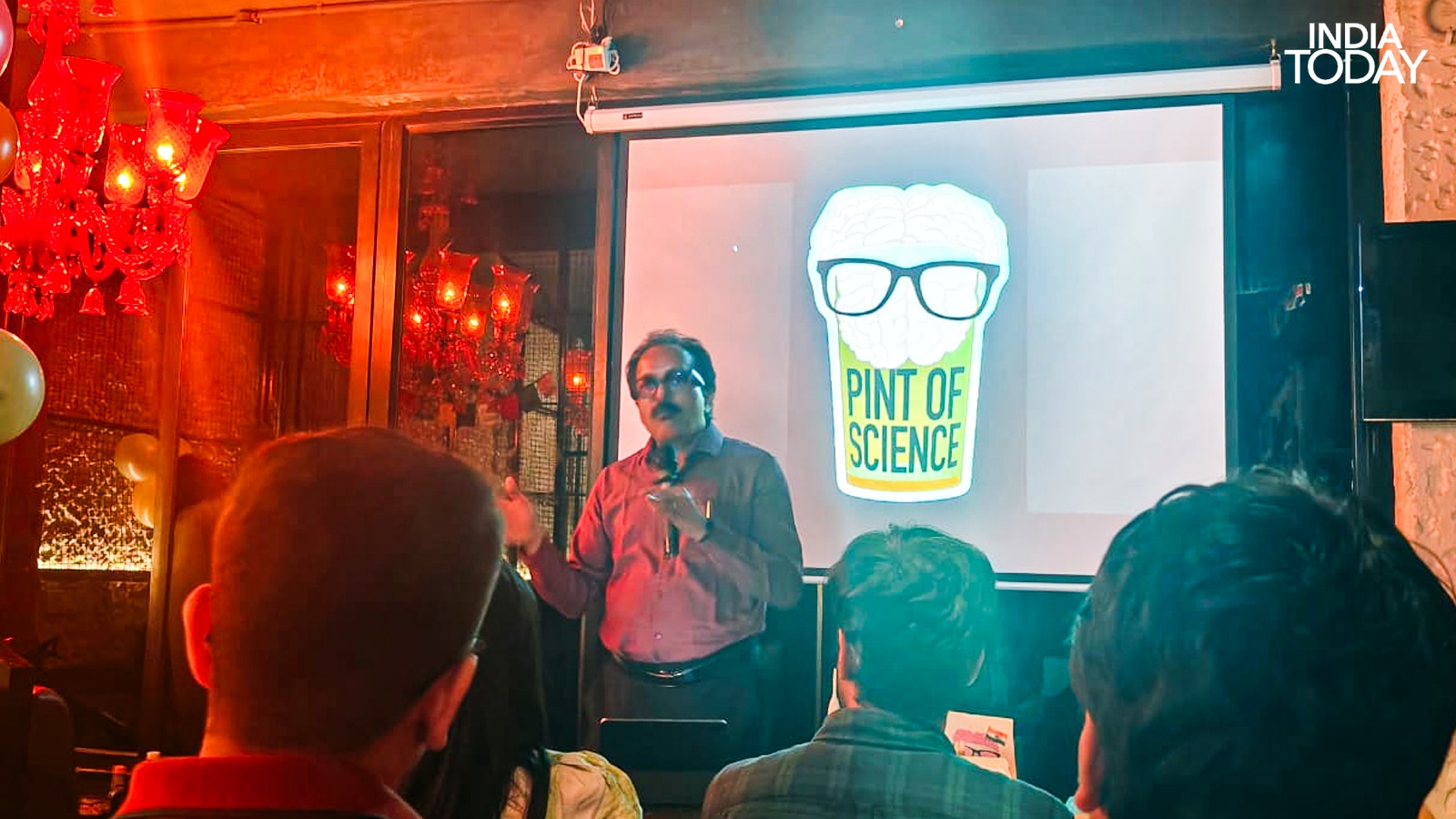 Dr S Somanath at Pint of Science 2026. The man who built things that left the Earth stood beneath a logo that puts a brain in a beer glass and told a room full of strangers the honest version of what that involved. Yes, he said pleasantly, rockets generate vibrations that nobody fully anticipated. This is a known problem. We work with it. (Photo: Radifah Kabir/India Today)