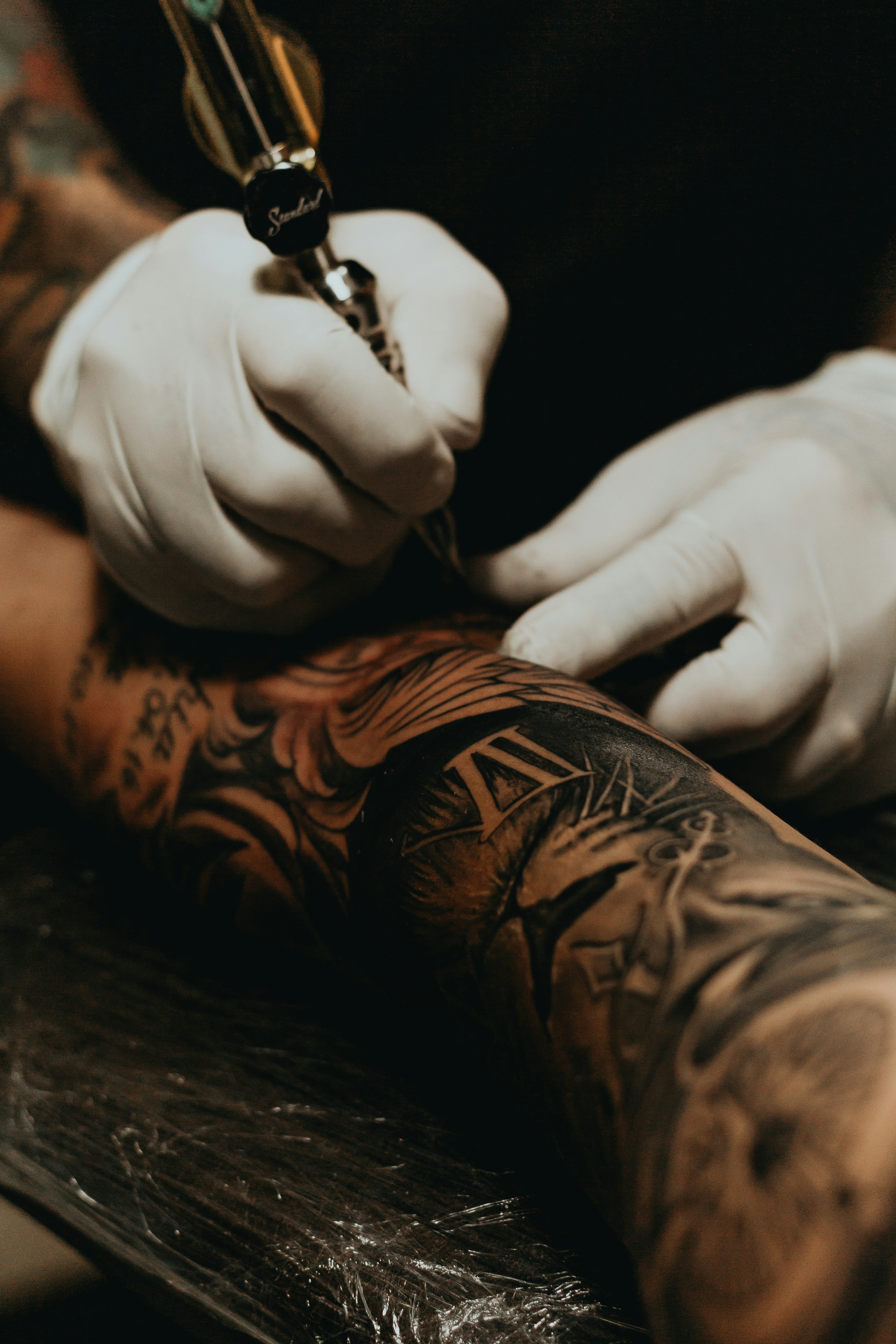 Macrophages, the cleanup crew of your immune system, swallow tattoo ink but cannot digest it, holding the pigment in place for years. (Photo: Unsplash)