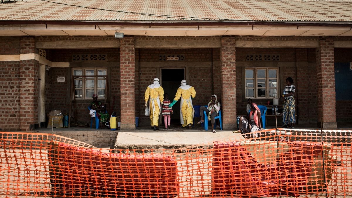 Medical workers lead a young girl with suspected Ebola into the unconfirmed Ebola patients ward run by The Alliance for International Medical Action (ALIMA). (Photo: AFP)