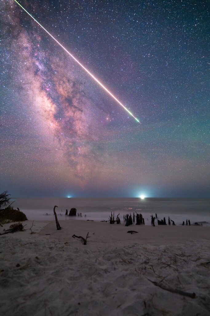 A bright fireball meteor moves slowly across the Milky Way above Cape San Blas, Florida, leaving a glowing trail that remained visible in the sky for almost fifteen minutes. Photographer Jason Rice had not planned to be there that night, and his time-lapse camera captured the entire event by chance. (Photo credit: Jason Rice/Capture the Atlas)