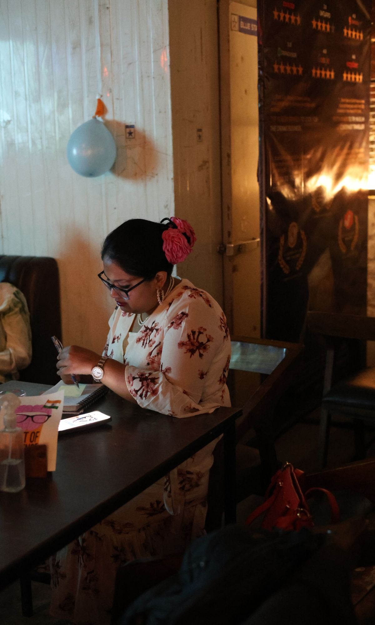 Me going through the programme at Pint of Science 2026, Delhi. Three nights, six scientists, a sold-out festival. I had a lot of notes to take.
