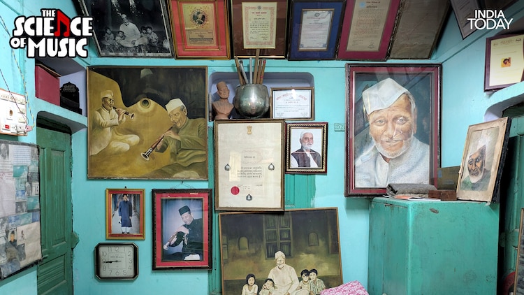 A wall in Ustad Bismillah Khan's Varanasi home, lined with portraits, certificates, and citations from across his lifetime, including the Bharat Ratna citation at the centre. The painting on the left shows him performing in profile, the very image of a man who lived for the instrument he played. (Photo: PTI)