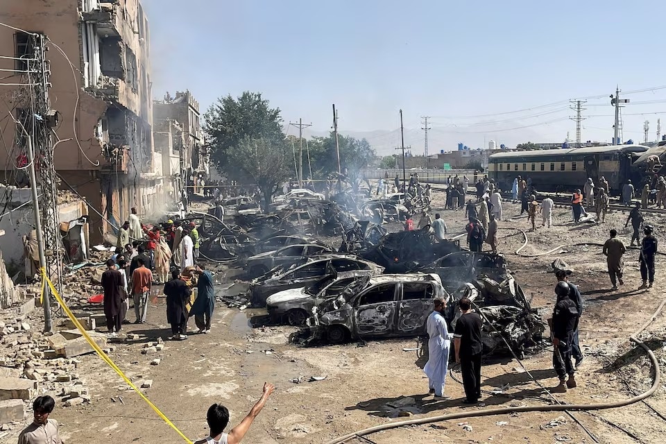 People and police officers gather after a blast near a railway track in Quetta. (Image: Reuters)
