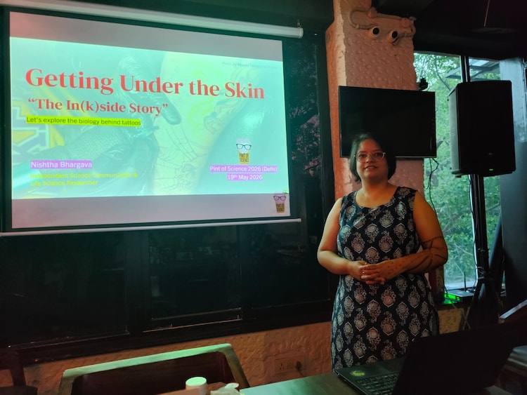 Dr Nishtha Bhargava, an independent science communicator, at Pint of Science 2026, Delhi. She opened her Tuesday session with a photograph of a tattooed forearm and spent the next hour explaining why a tattoo belongs to whoever's macrophages happen to be on duty.