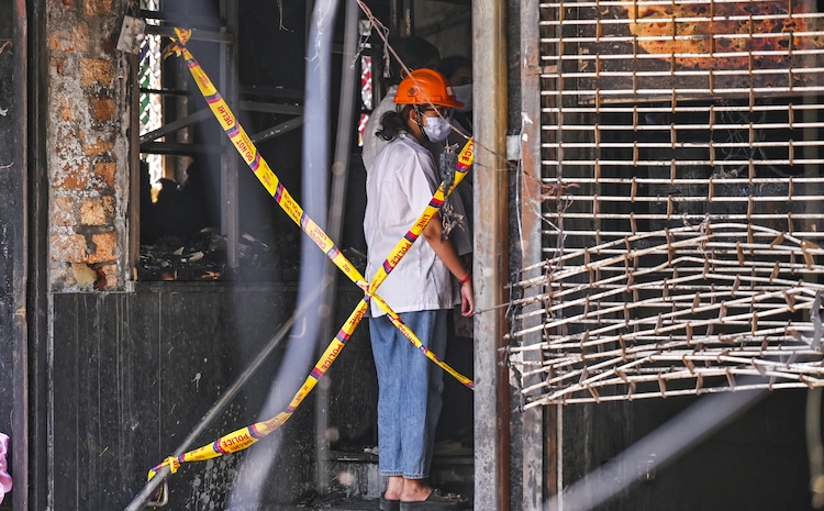 A forensic official at the site after a fire broke out at a bed-and-breakfast in a five-storey building in south Delhi's Malviya Nagar area. (Photo: PTI)