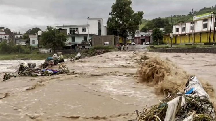 Floodwater rushes through Jammu and Kashmir after a burst of intense rainfall. (Photo: PTI)