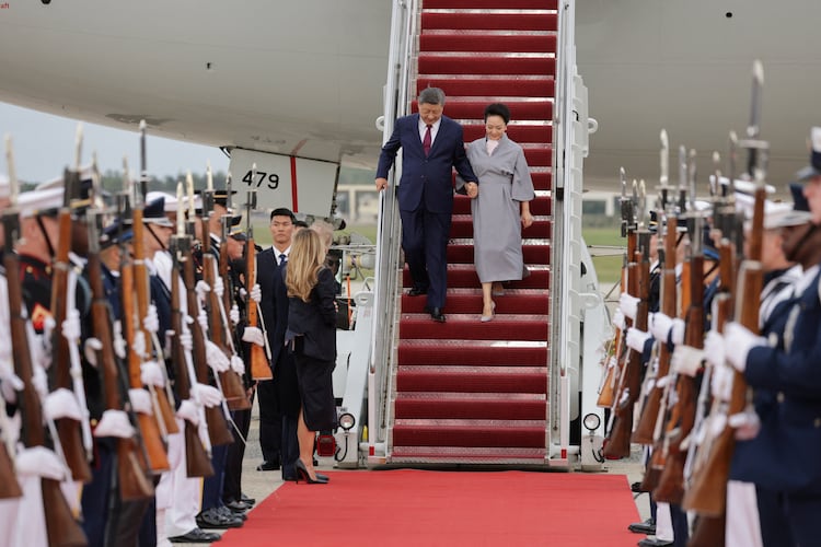 China's President Xi Jinping and his wife Peng Liyuan disembark upon their arrival ahead of a state visit at Joint Base Andrews