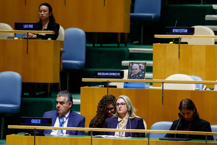 Iranian delegationâs seats, with a portrait of late military commander Qassem Soleimani displayed.