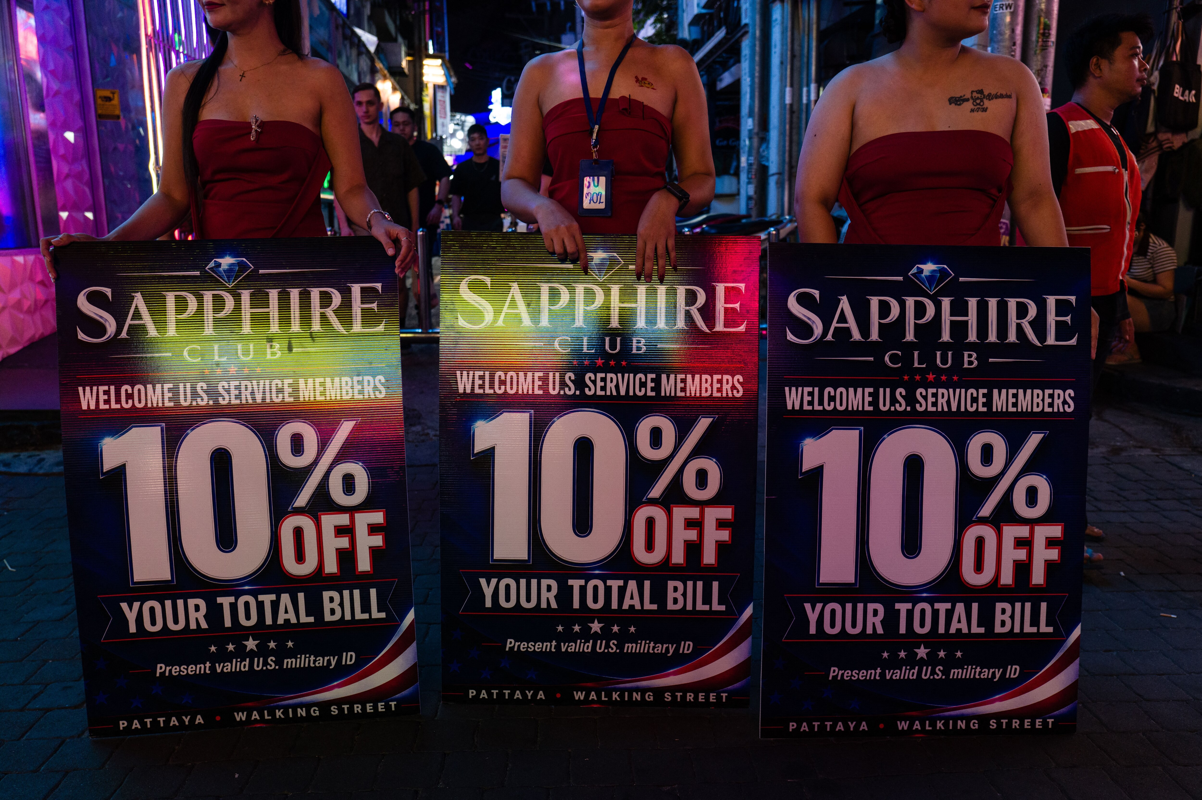 The Sapphire Club deployed three women in strapless black bodysuits to offer discounts to US military ID holders. (Image: AFP)